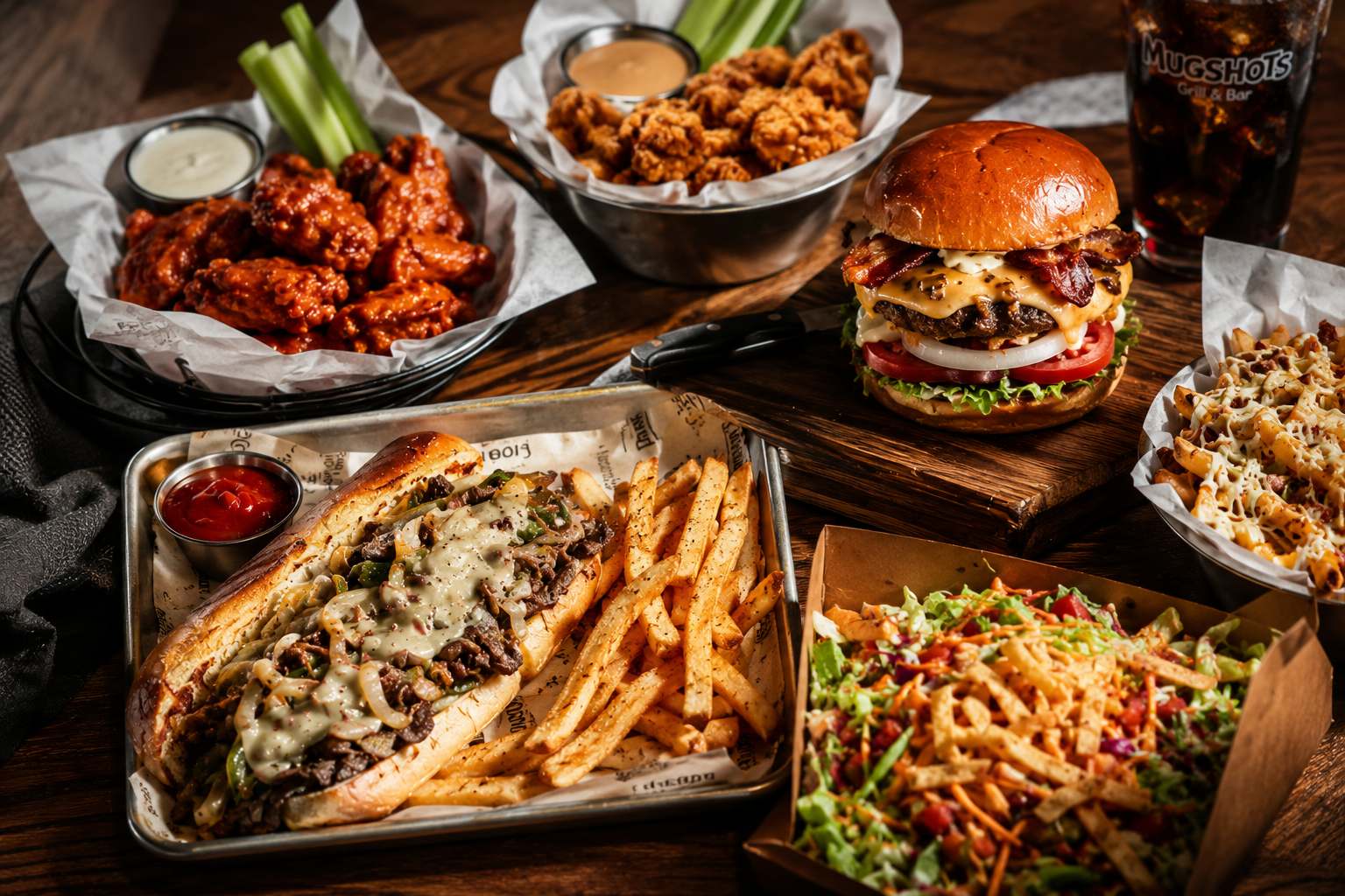 Prime Burger & Chicken catering spread — burgers, philly, wings, loaded fries and tenders